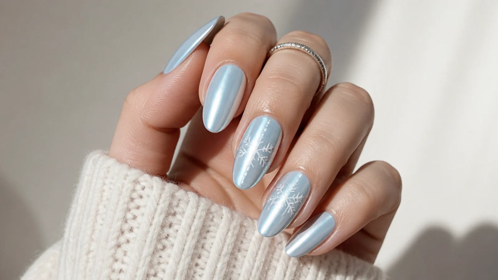 Icy pale blue chrome December nails with a frosted mirror finish