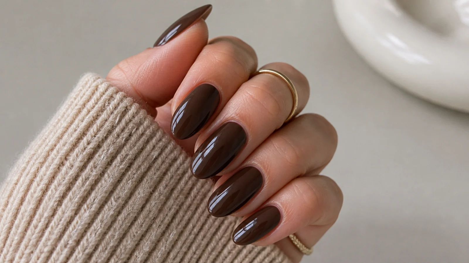 Almond nails in glossy chocolate brown with a glazed high-shine finish