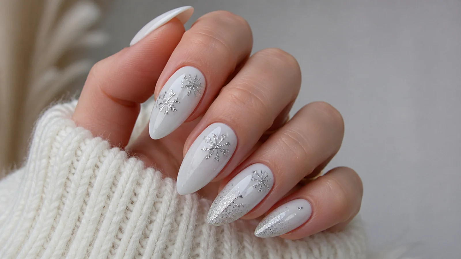 Icy white December nails with delicate silver snowflake and glitter accents