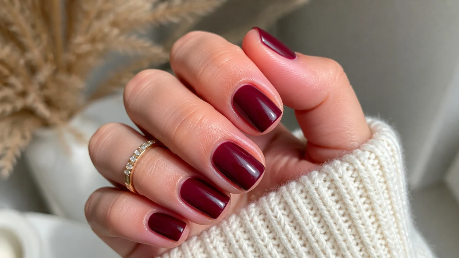 Short square December nails in glossy deep cranberry red