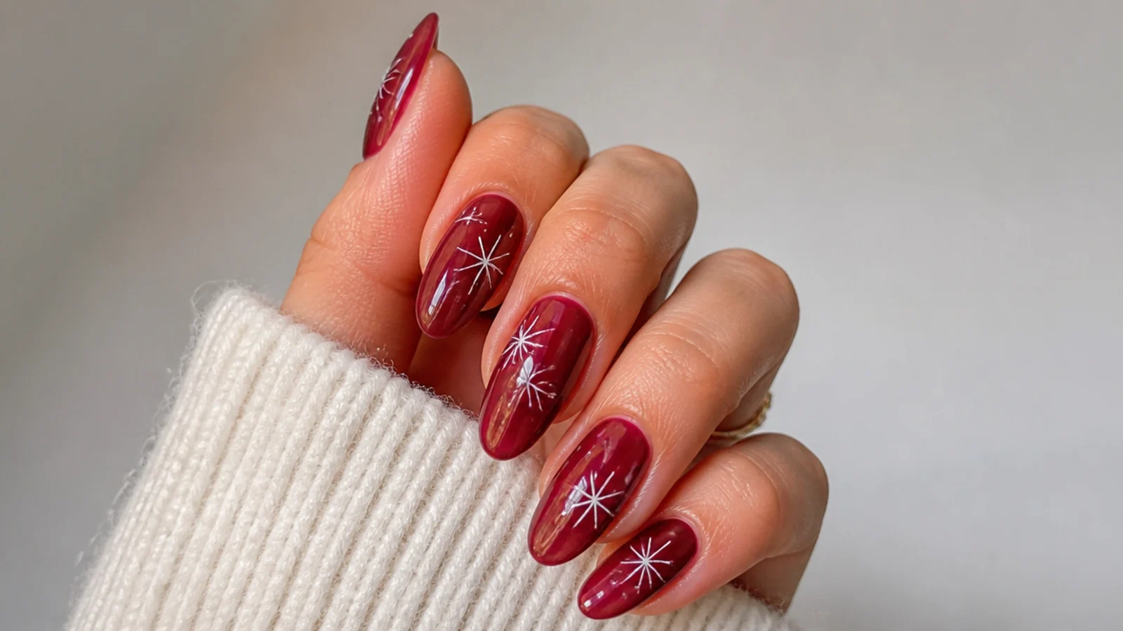 Sheer cranberry jelly December nails on a long almond shape