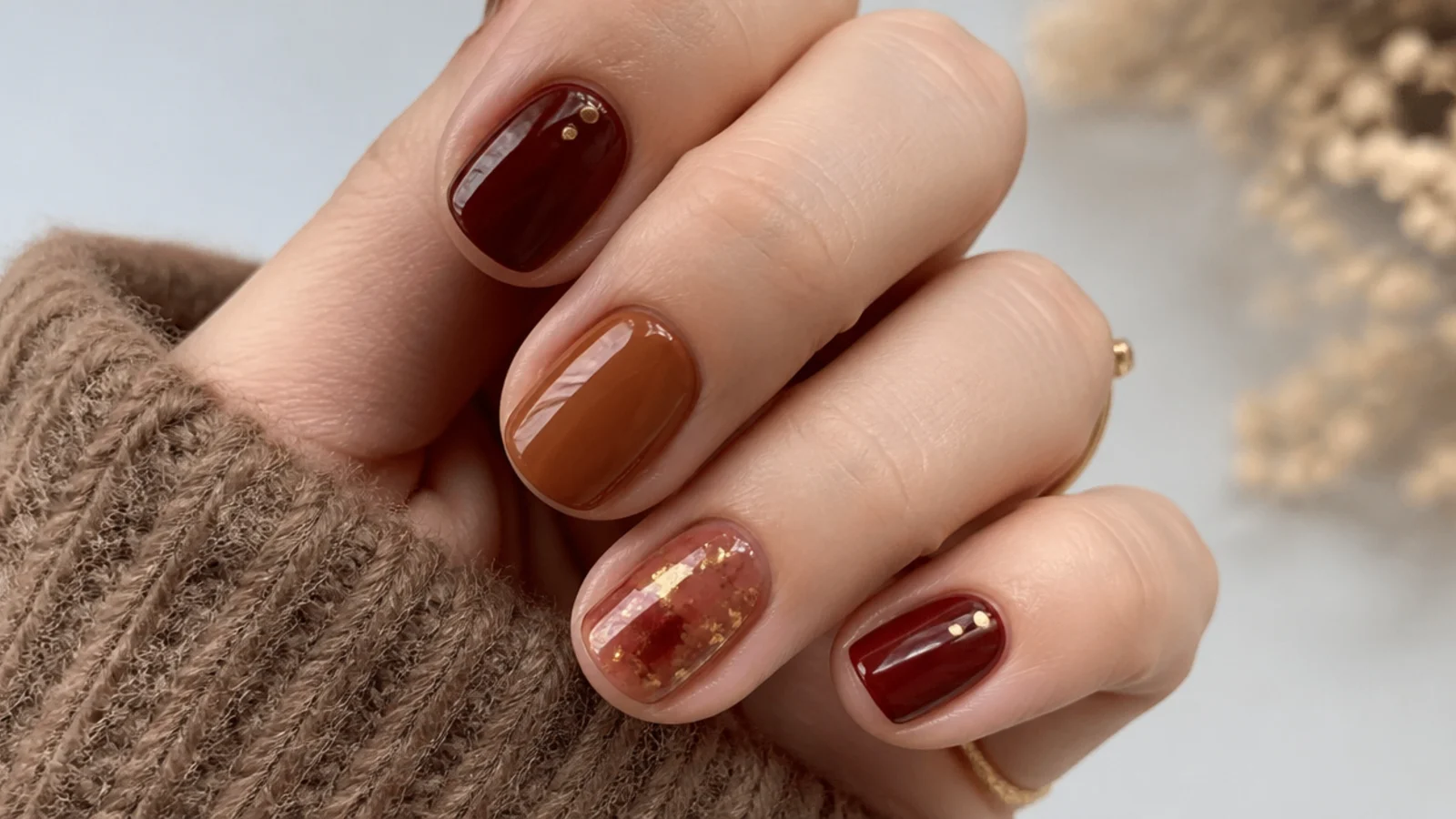 Short cranberry and cinnamon brown December nails on round tips