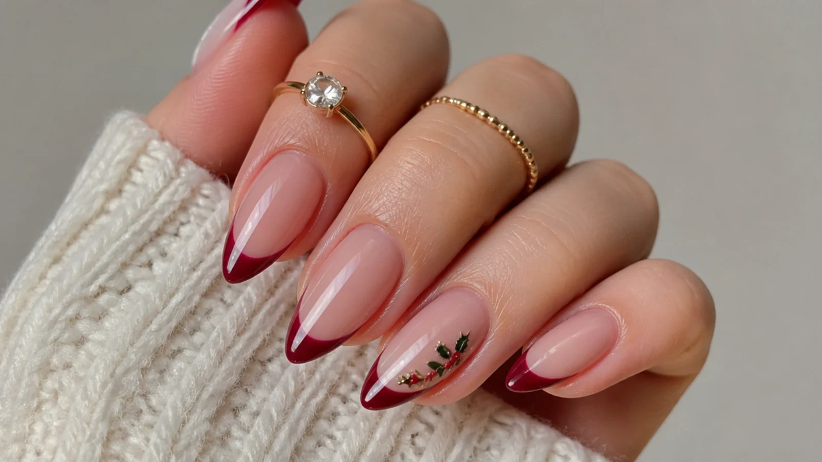Cranberry red French tip December nails on a sheer nude base