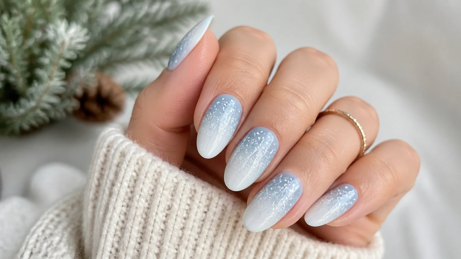 Glacier blue to white ombre December nails with a frosty fade