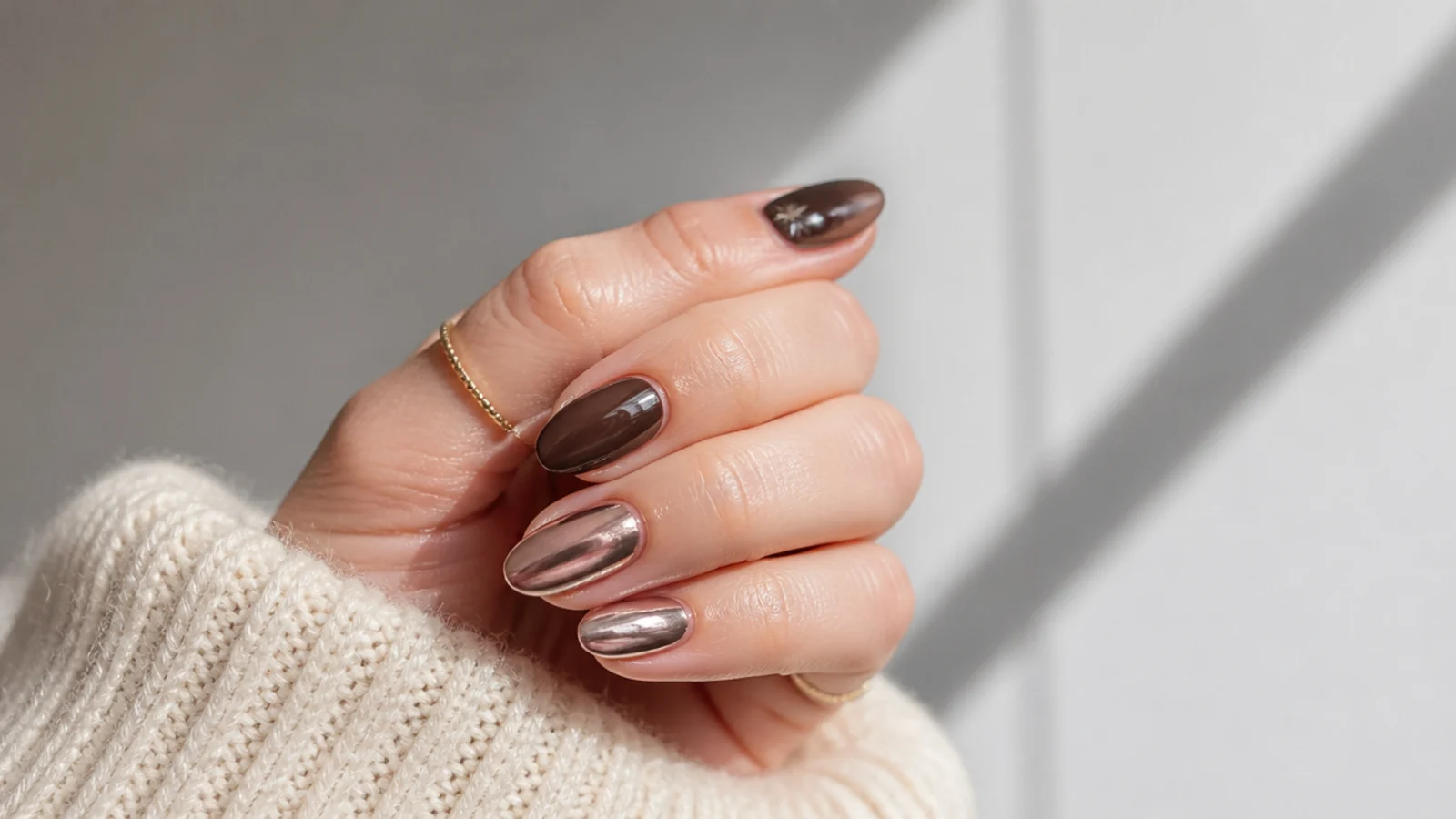 Simple December nails in chocolate brown and soft chrome on short almond shapes