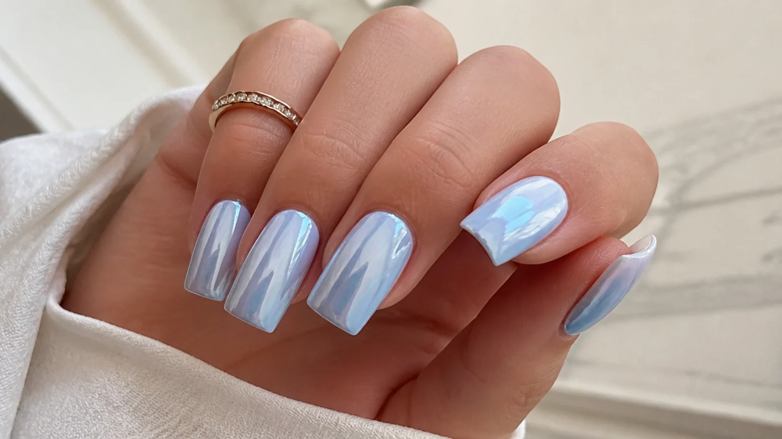 Icy pale blue chrome square nails with a mirror finish