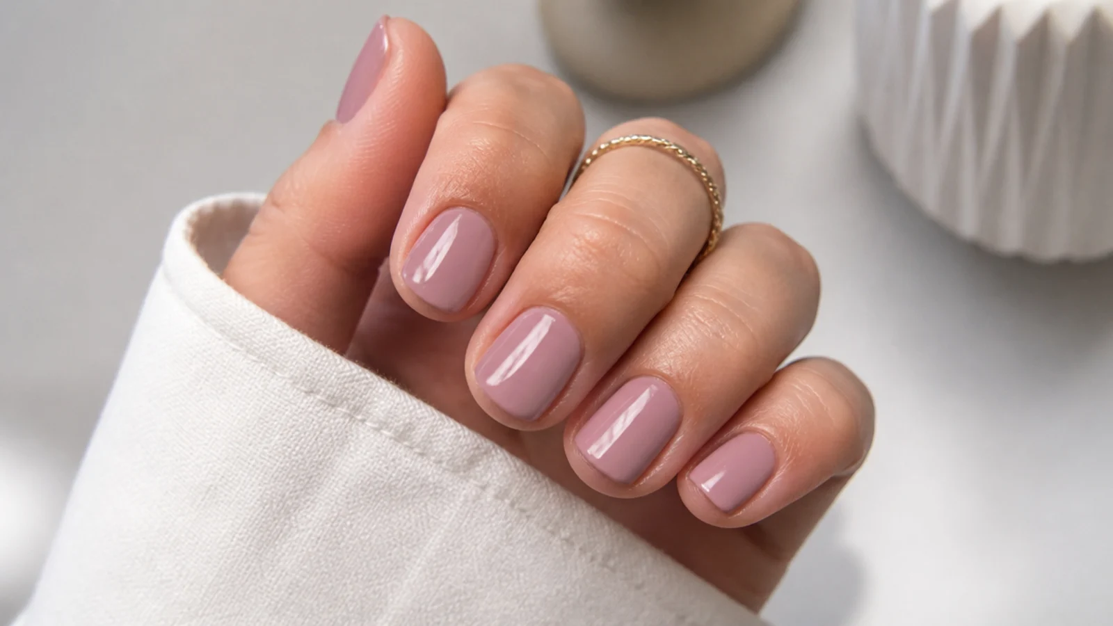 Short square nails in soft milky mauve with a clean office finish