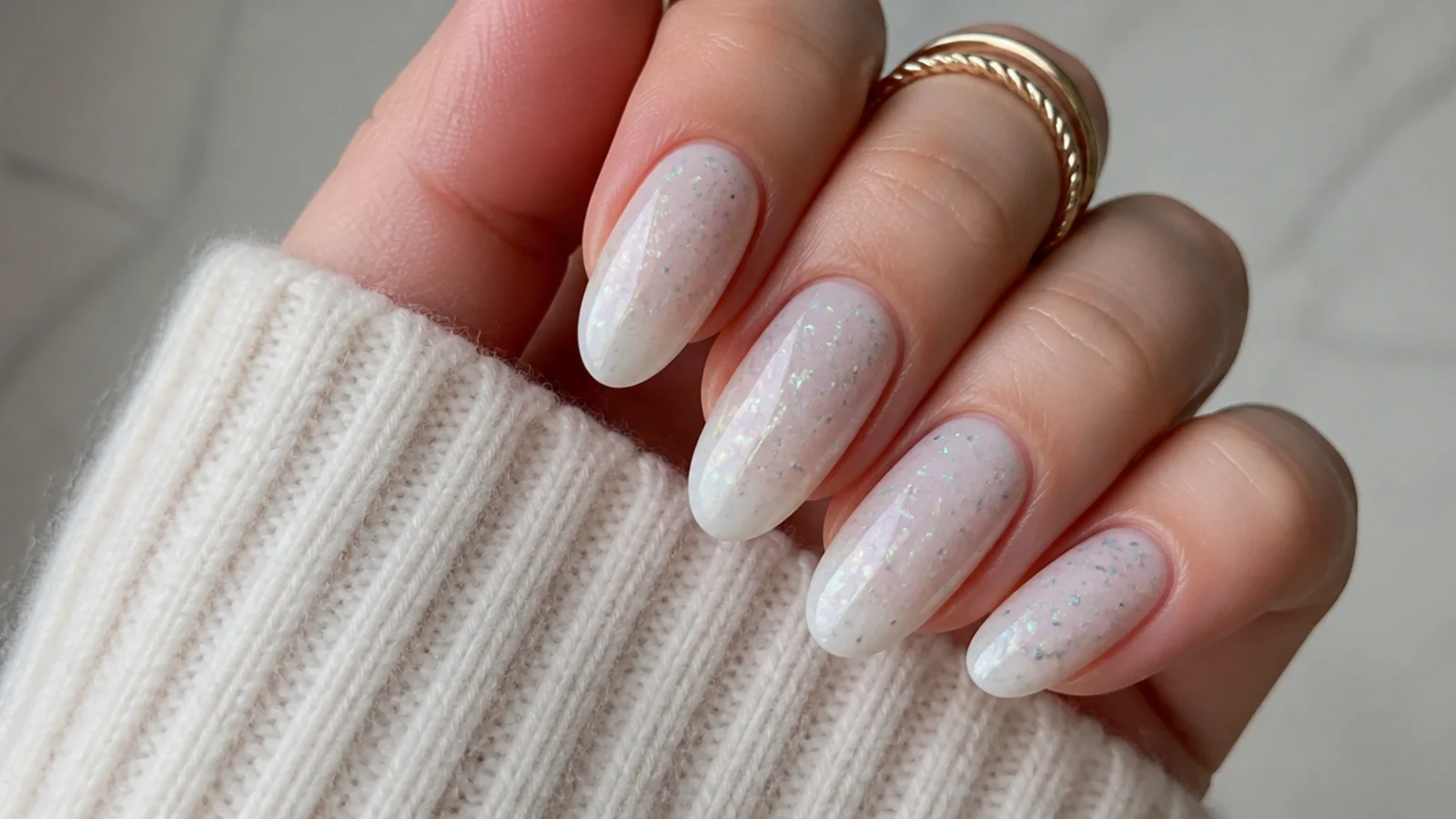Milky white December nails with iridescent color-shifting flakes