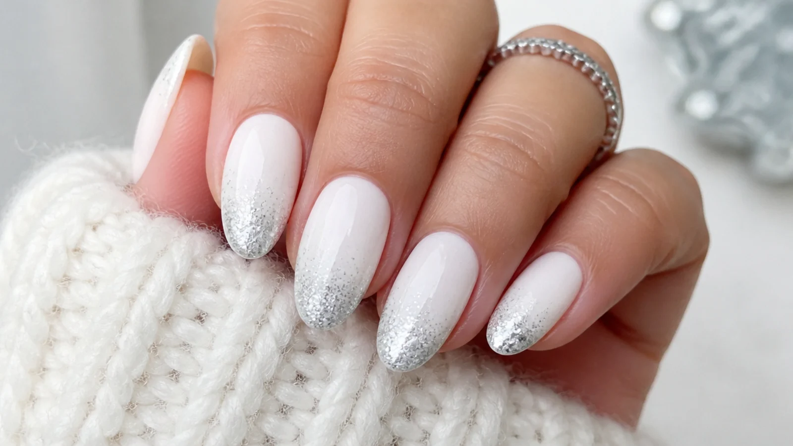 White December nails with silver glitter faded onto the tips