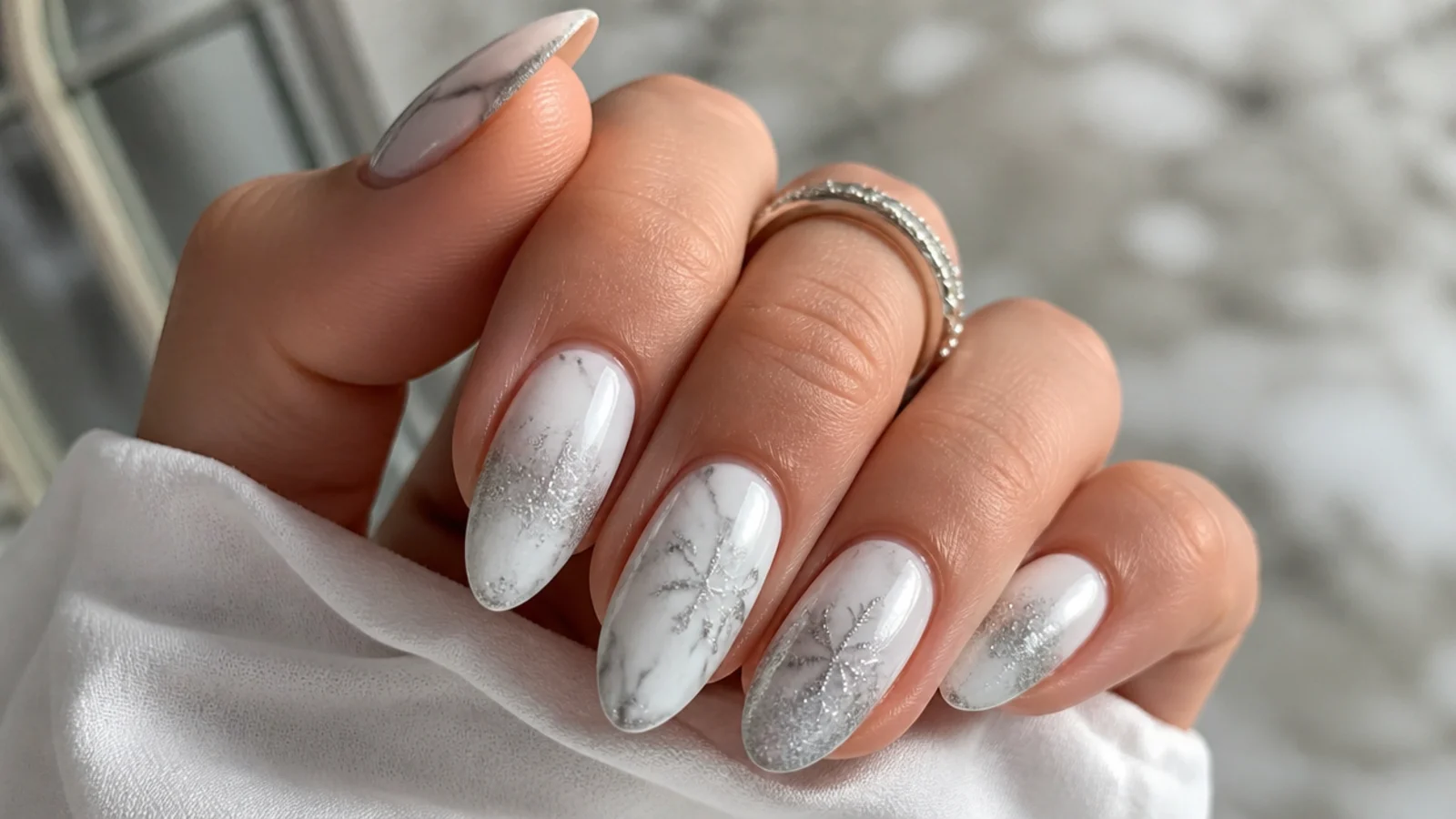White and silver frosted marble December nails with soft veining