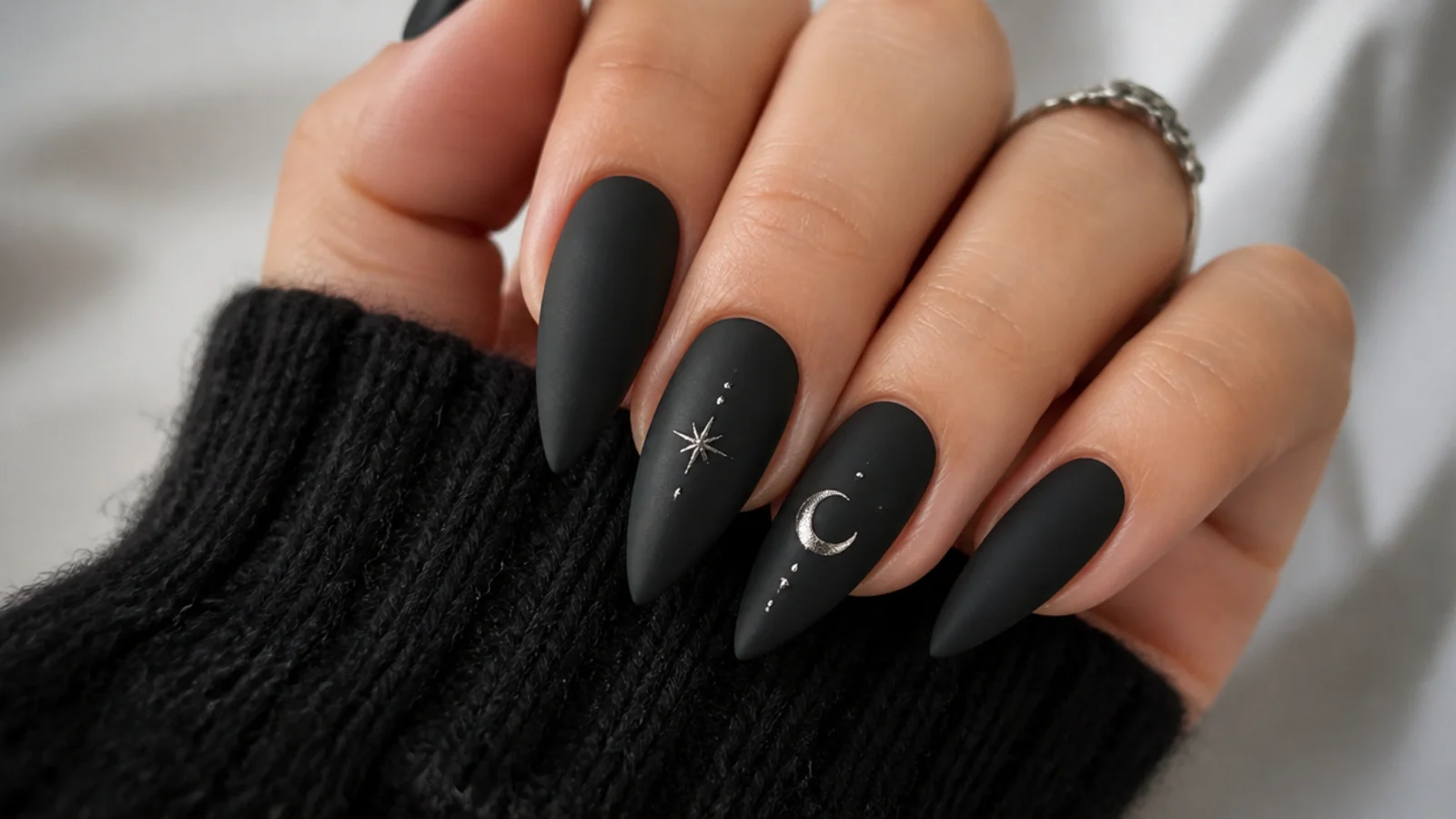 Sharp matte black stiletto emo nails with a velvety finish