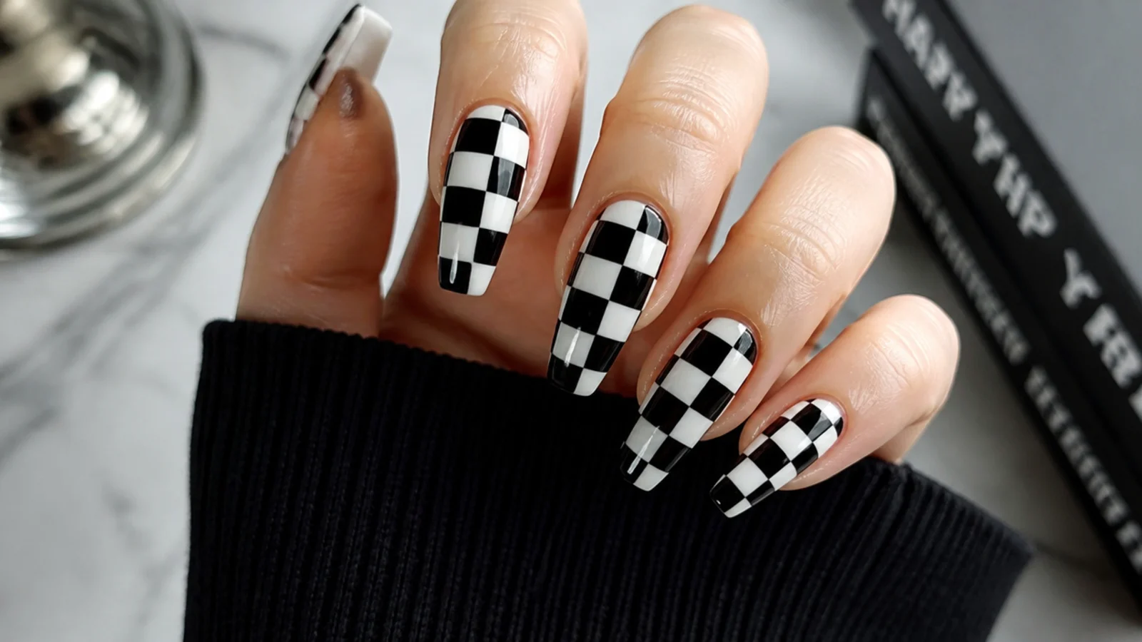 Classic black and white checkerboard emo nails on a coffin shape
