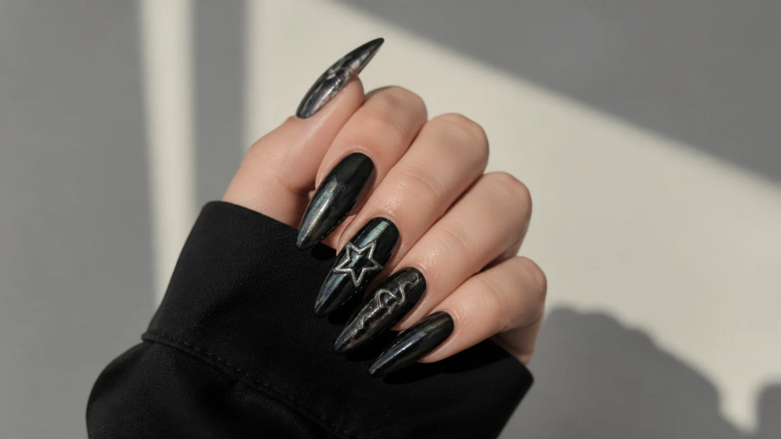 Dark chrome black emo nails with an oil-slick metallic sheen