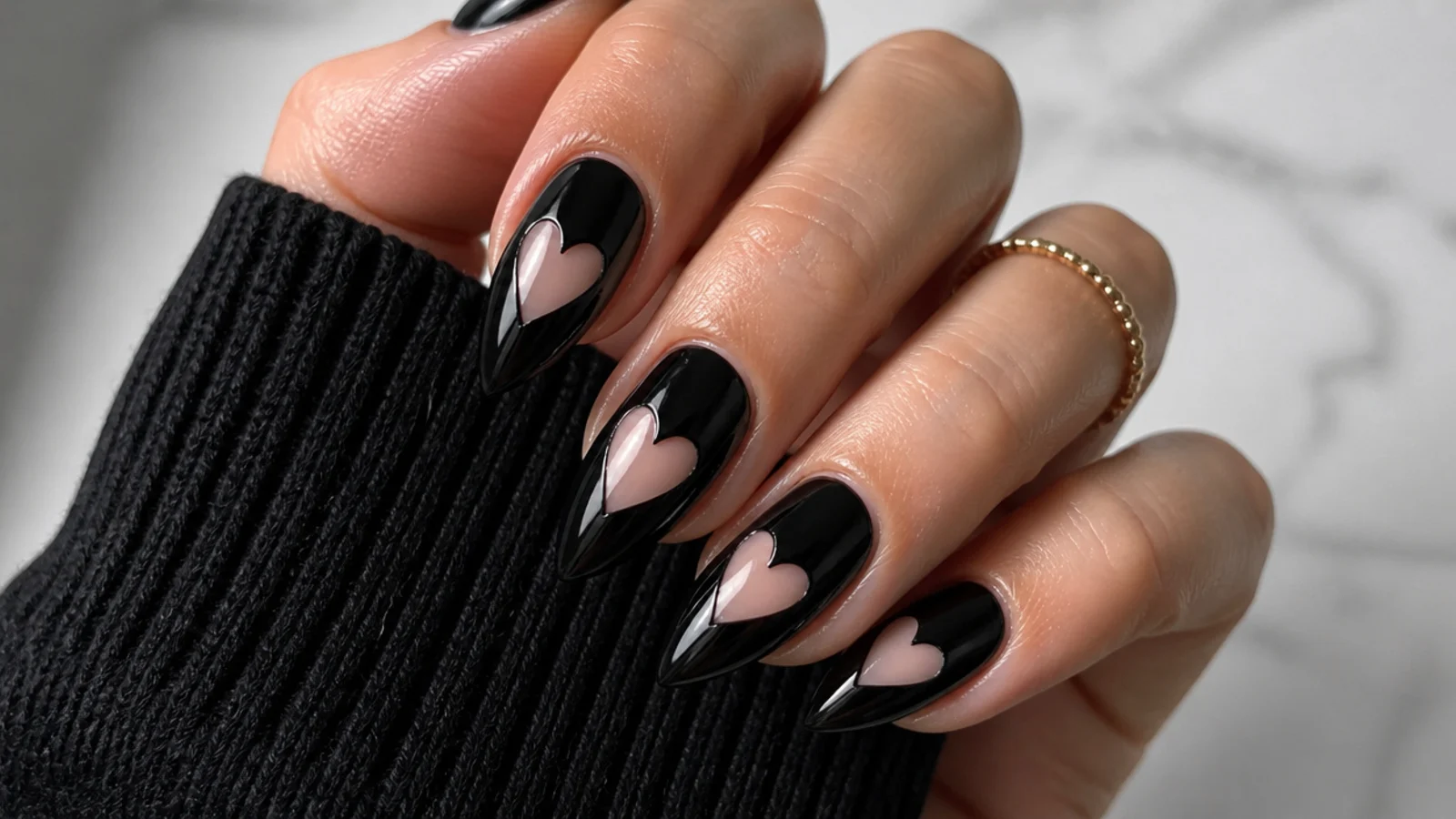 Black emo nails with a heart cut out to bare nail as negative space