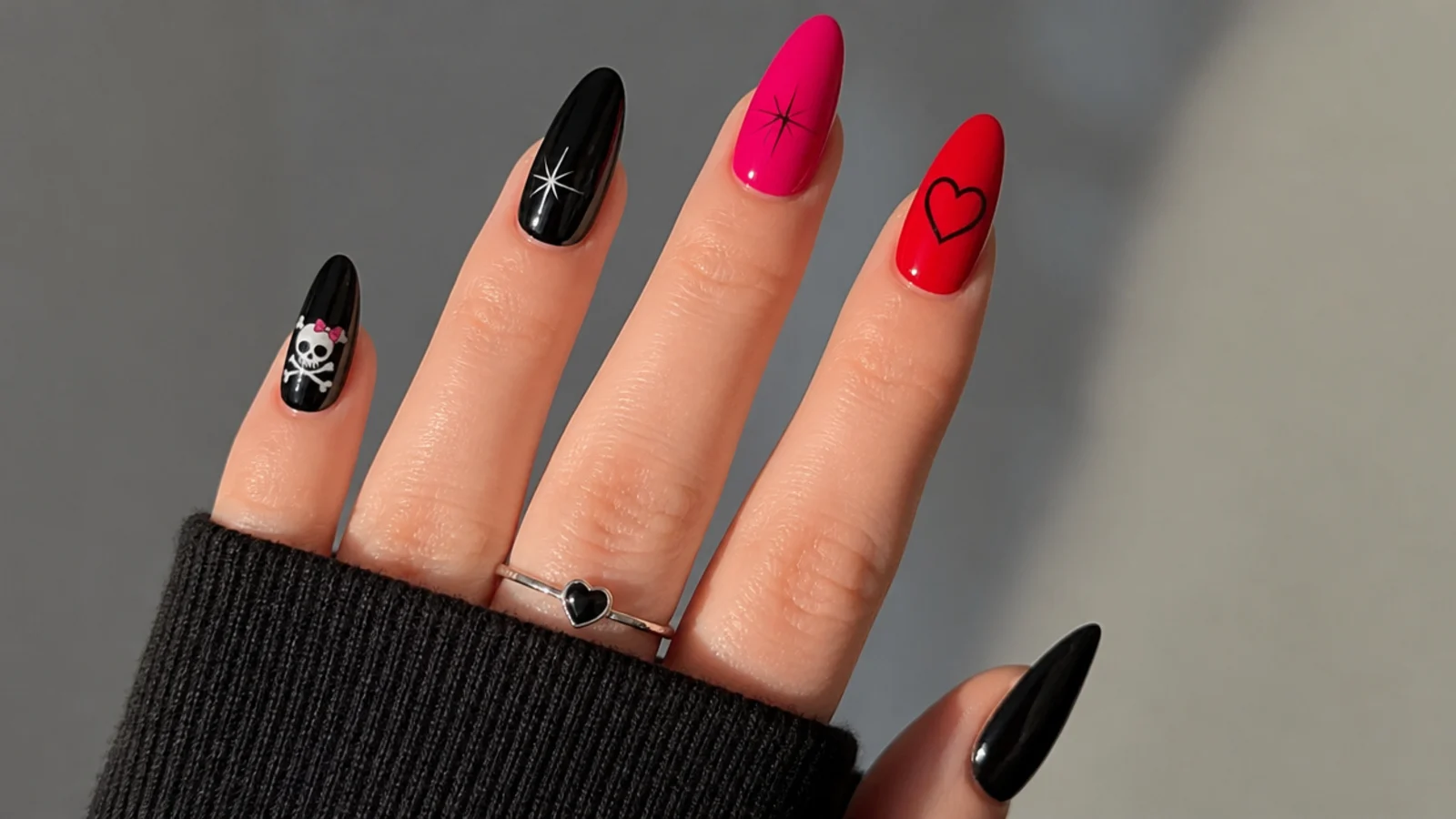 Swatches of black, hot pink and red with emo motif line art