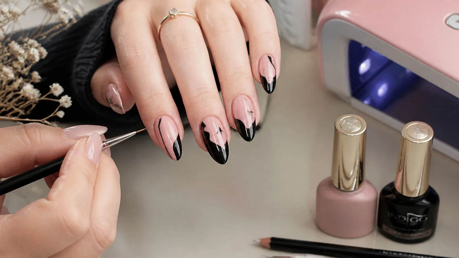 Black and pink gels, a fine liner brush and a lamp mid-emo-manicure at home