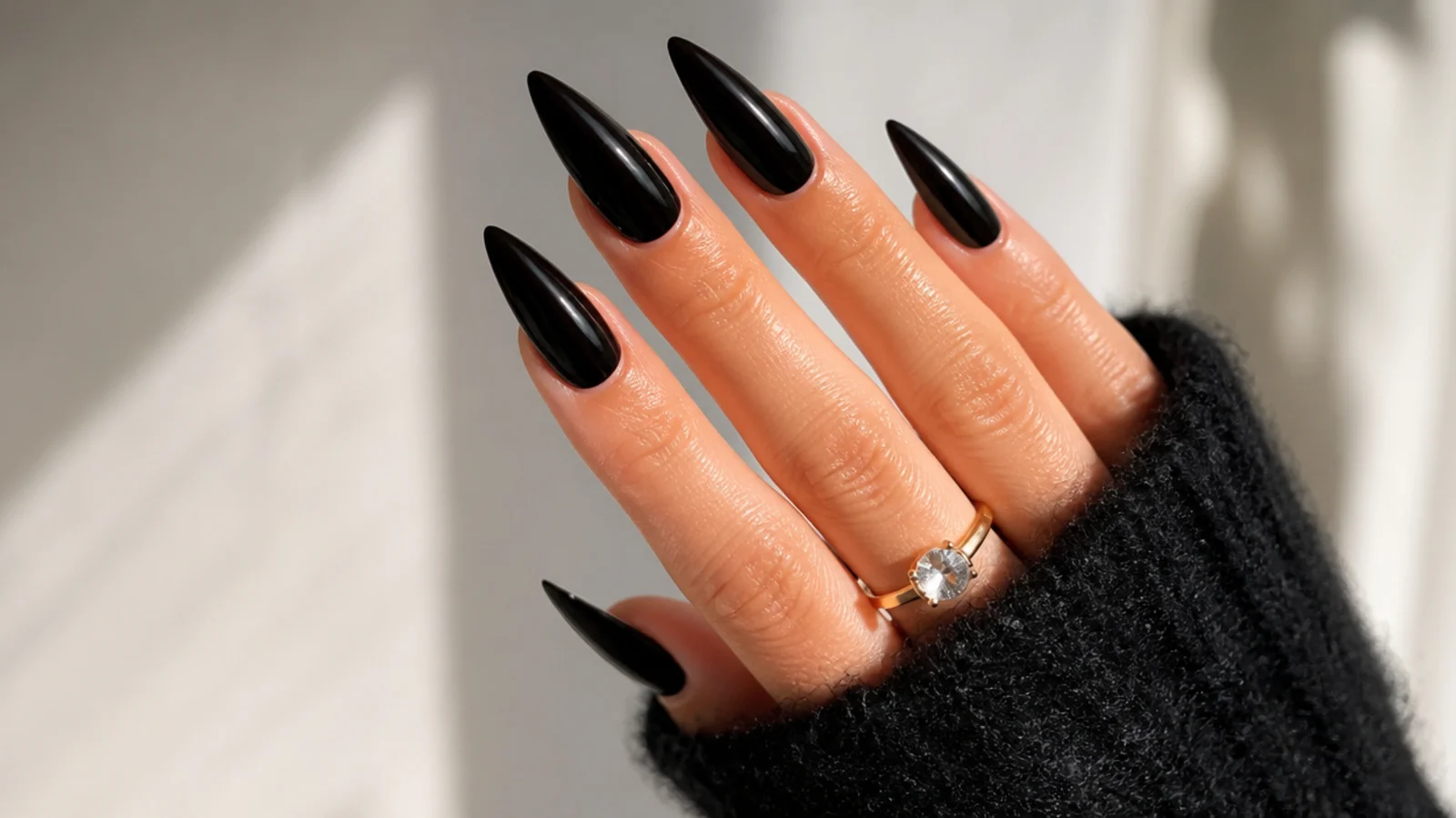 High-shine solid black stiletto acrylic nails