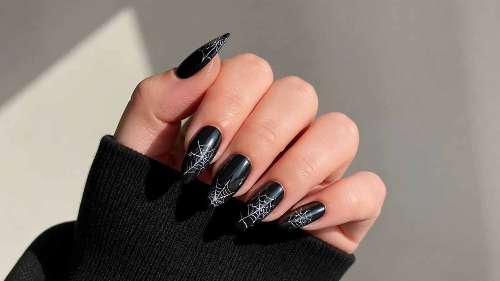 Fine white spiderweb detail on black acrylic nail tips