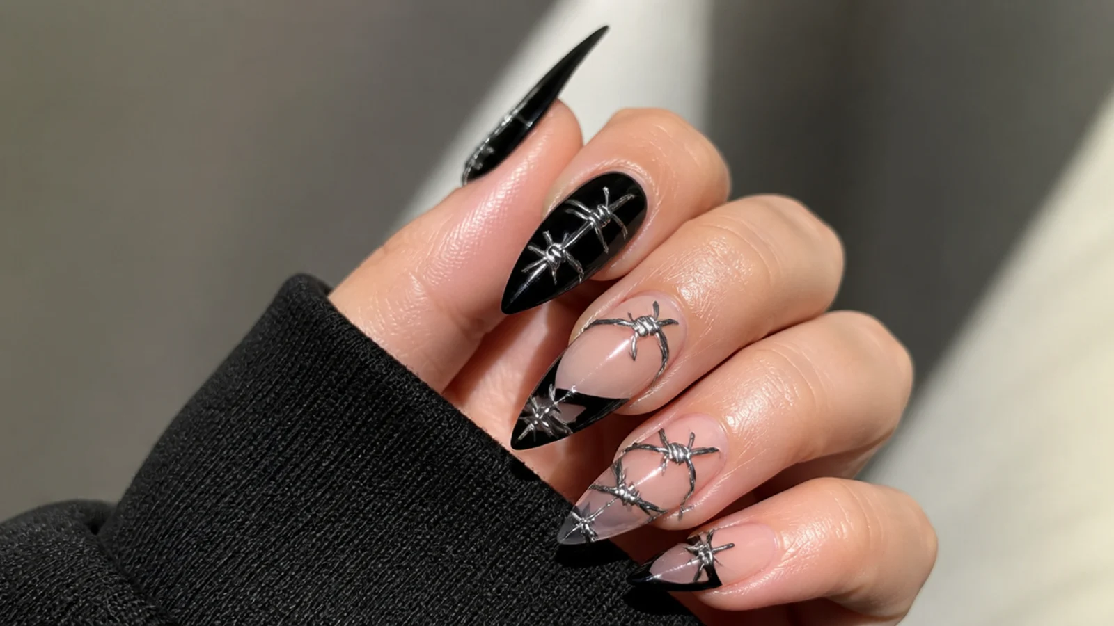 Silver barbed wire detail wrapping black and clear acrylic nails