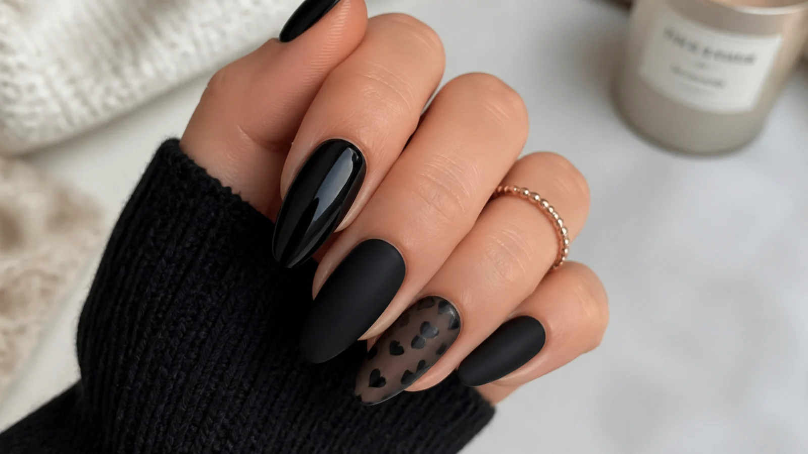 Black acrylic nails mixing matte and glossy finishes in a pattern