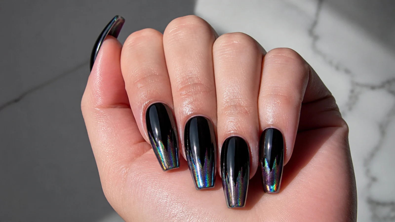 Black acrylic nails with an oil-slick chrome ombre at the tips
