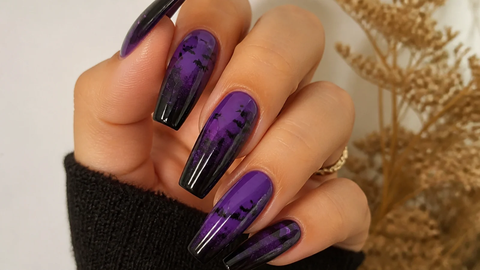 Small black bats silhouetted over a deep purple and black acrylic set