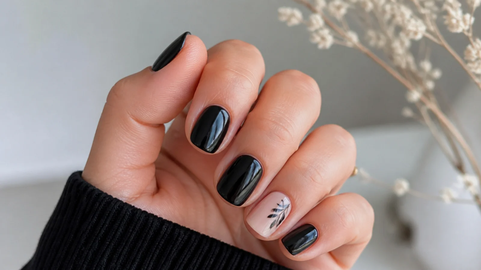 Short round black acrylic nails with a small motif for the office