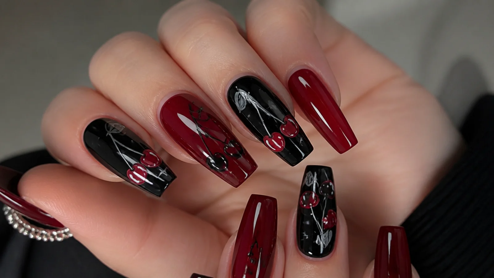Red and black cherry emo baddie nails with stems on a coffin shape