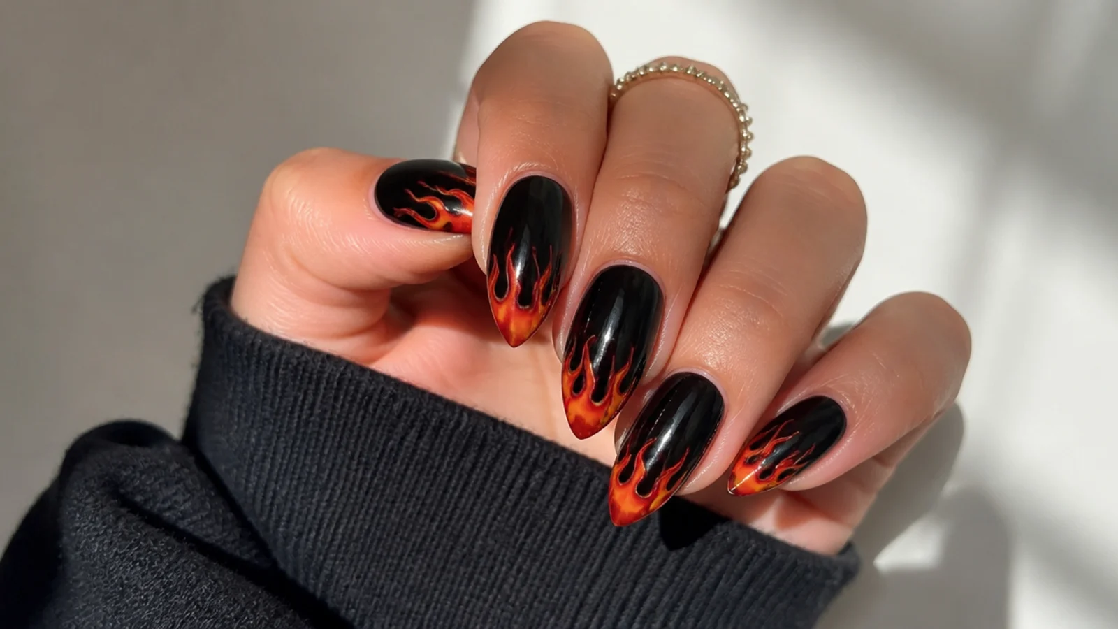 Black nails with red and orange flame tips, emo baddie style