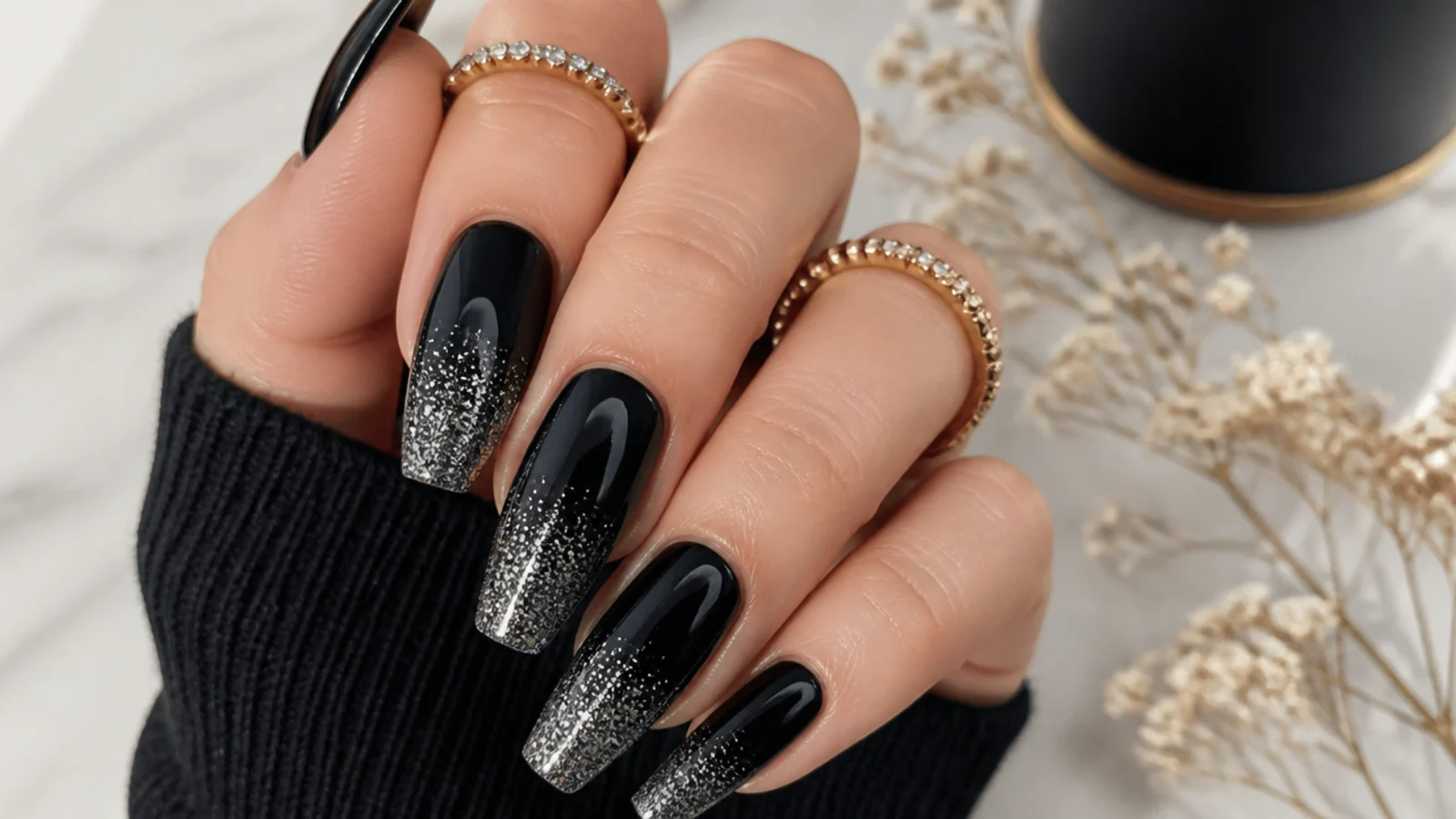Glossy black nails with fine silver glitter gradient on a coffin shape