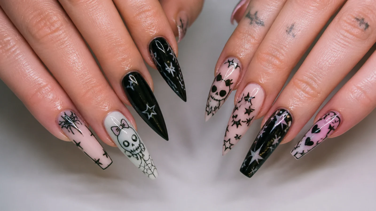 Almond, stiletto and coffin nail shapes shown with emo art