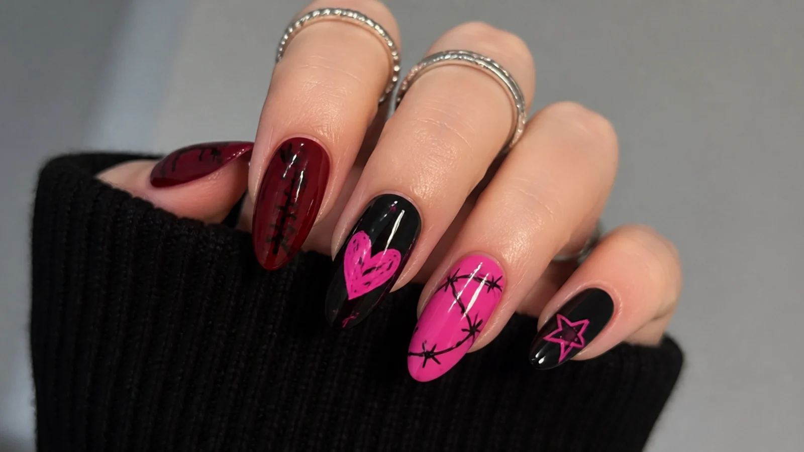 Swatches of black, hot pink and blood red with emo nail motifs