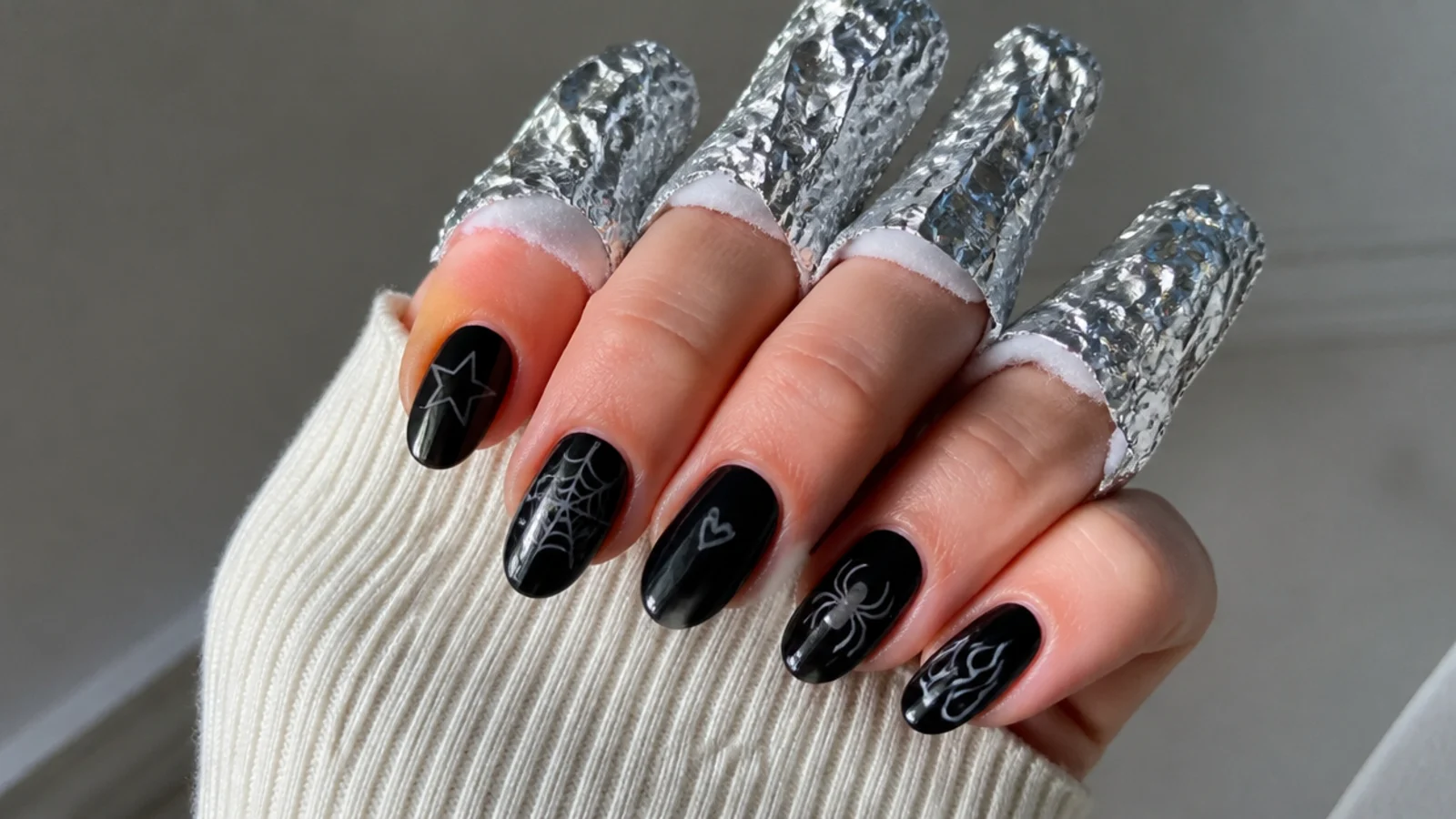 A well-sealed black emo manicure with acetone, foil and cotton for safe removal