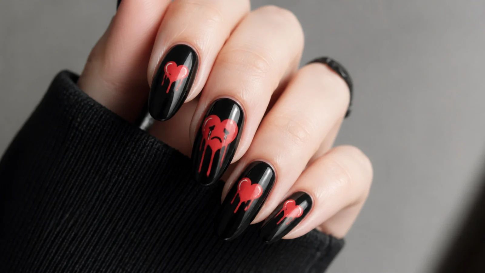 Black emo nails with a red crying heart and dripping tears