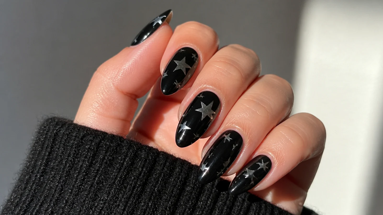 Black almond emo nails scattered with silver stars