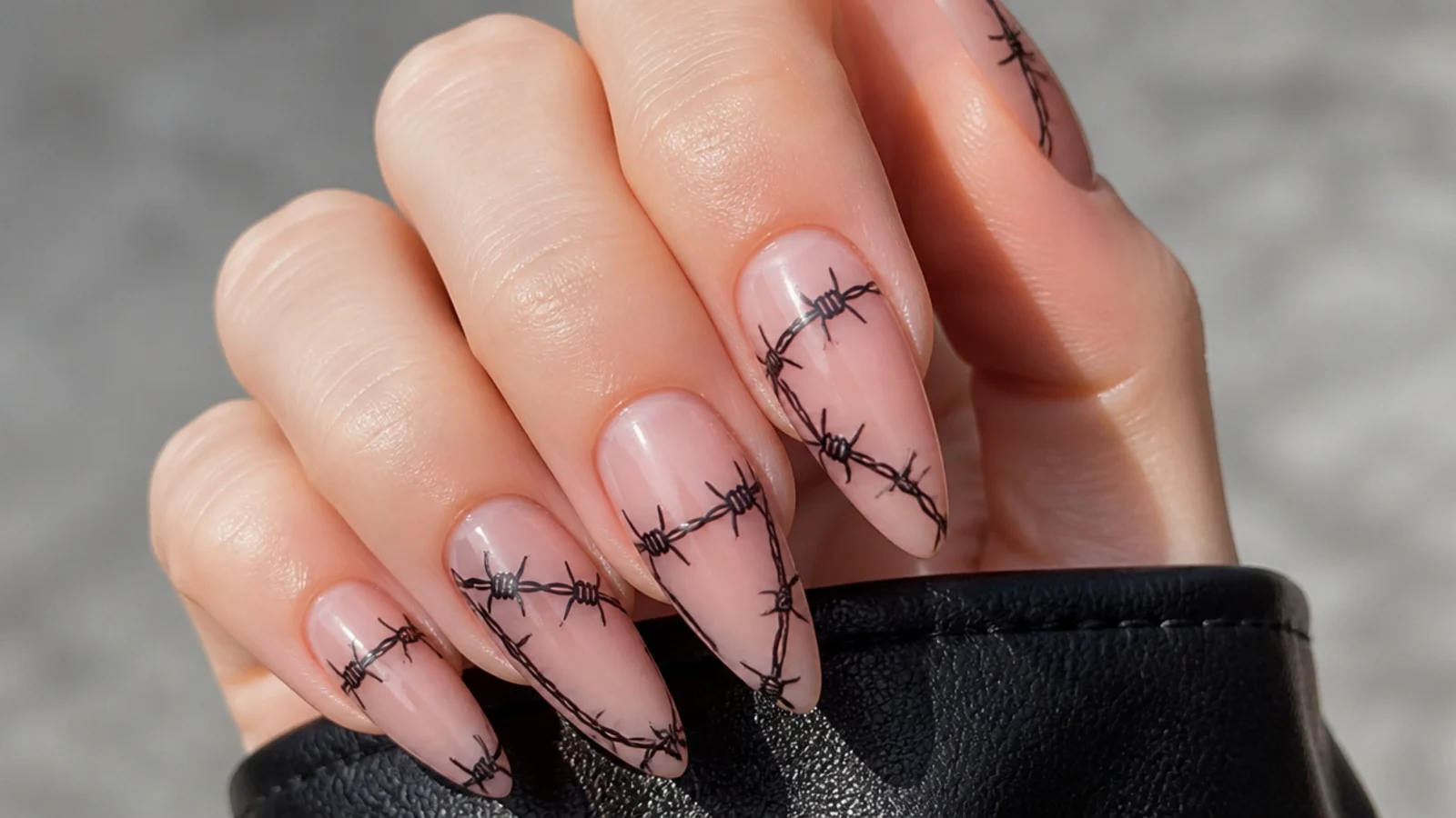 Nude emo nails with black barbwire wrapping around each nail