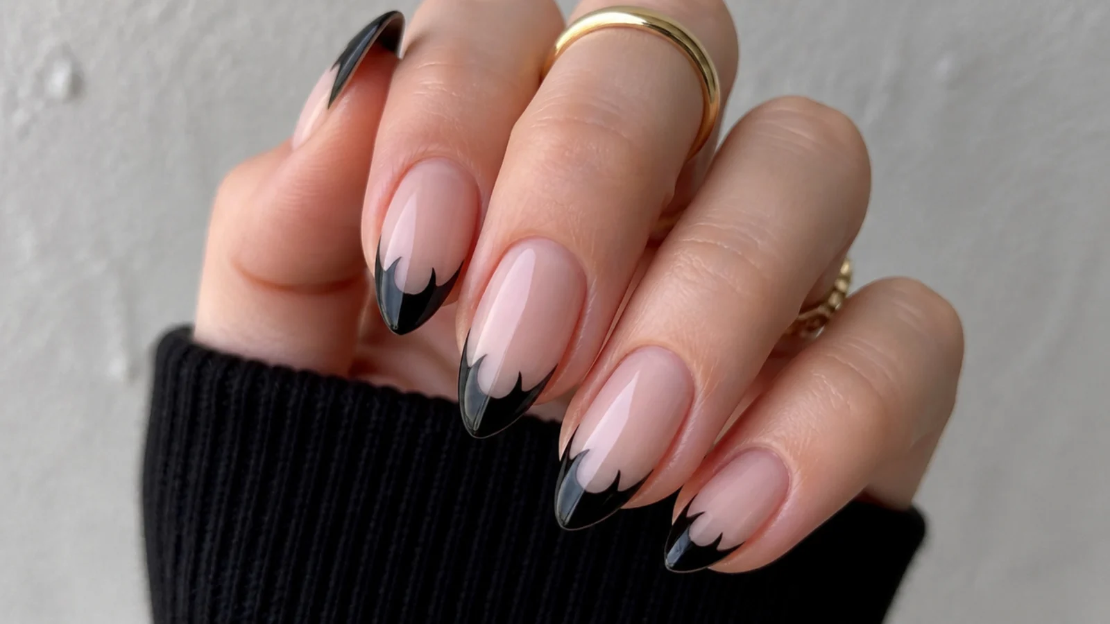 Nude emo nails with black French tips shaped into bat wings