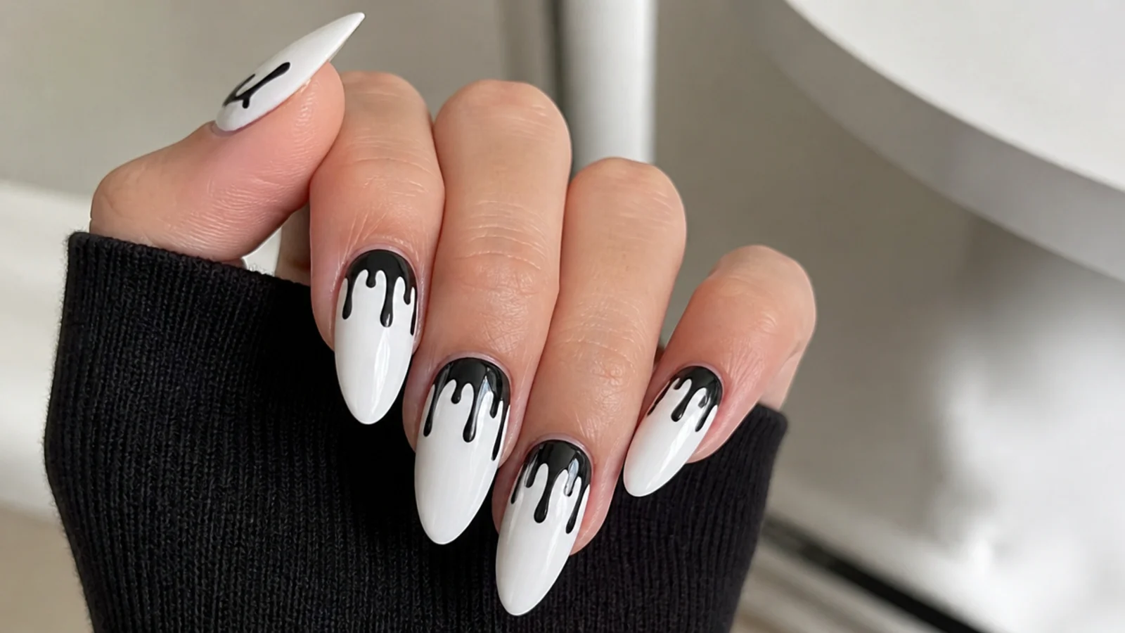 White emo nails with black paint dripping down from the cuticle