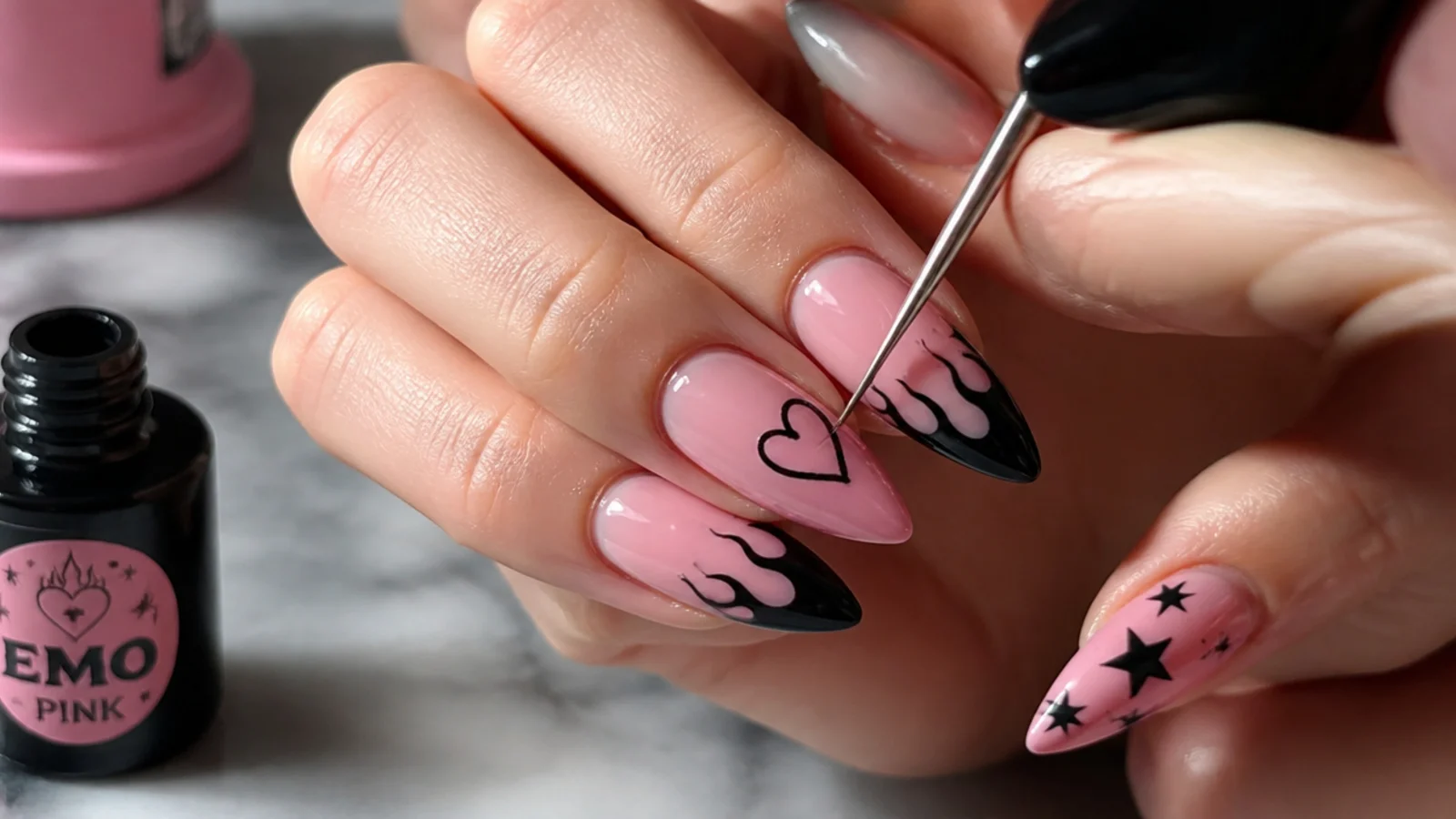 Emo nail supplies with a thin liner brush painting a black heart on pink