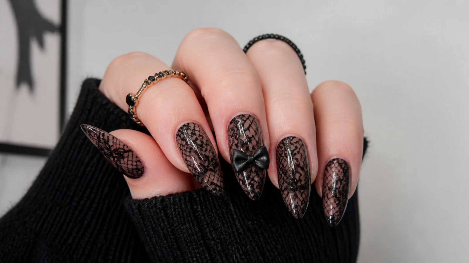 Sheer black emo nails with fine lace pattern and a black bow