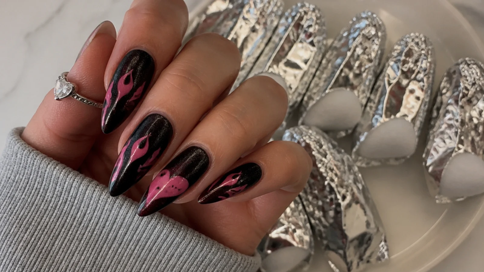 A gel emo manicure being soaked off in acetone-wrapped foils