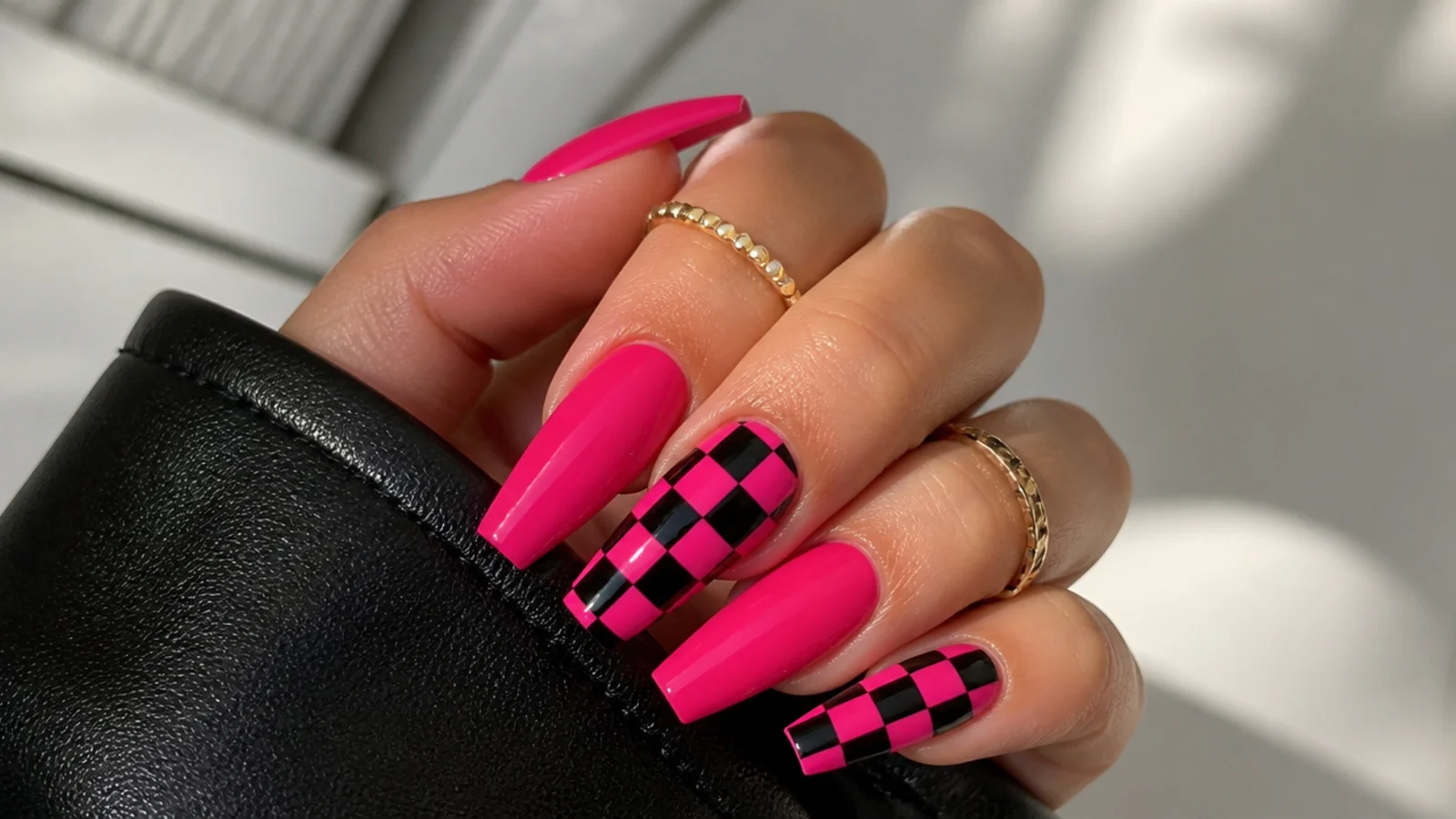 Hot pink and black checkerboard emo nails on coffin shape