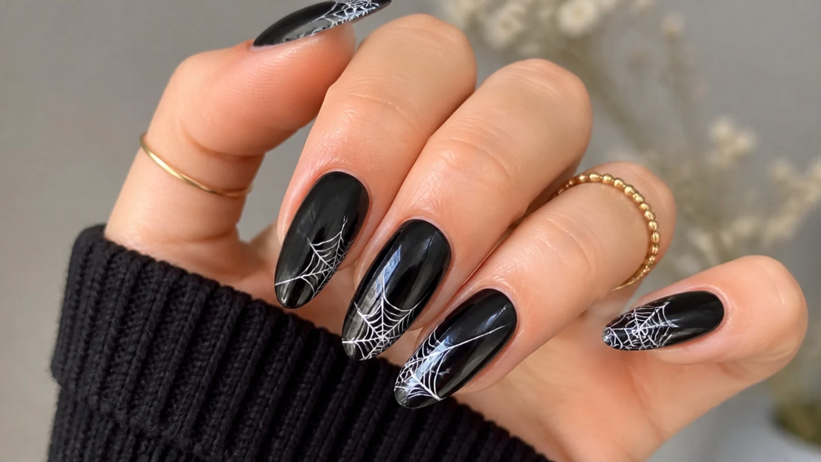 Black emo nails with fine white spiderweb art in the corner