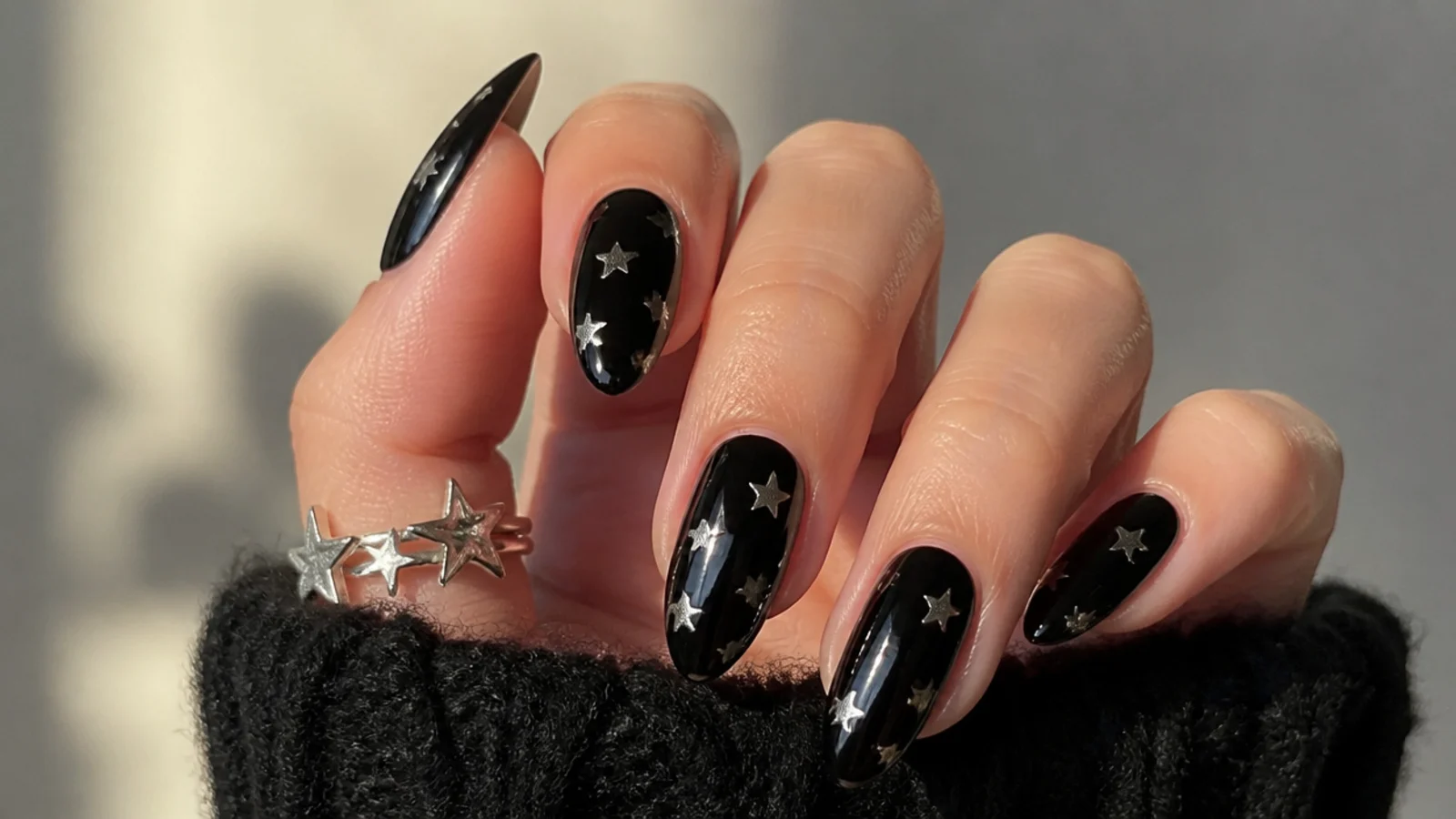 Black emo nails scattered with small silver stars