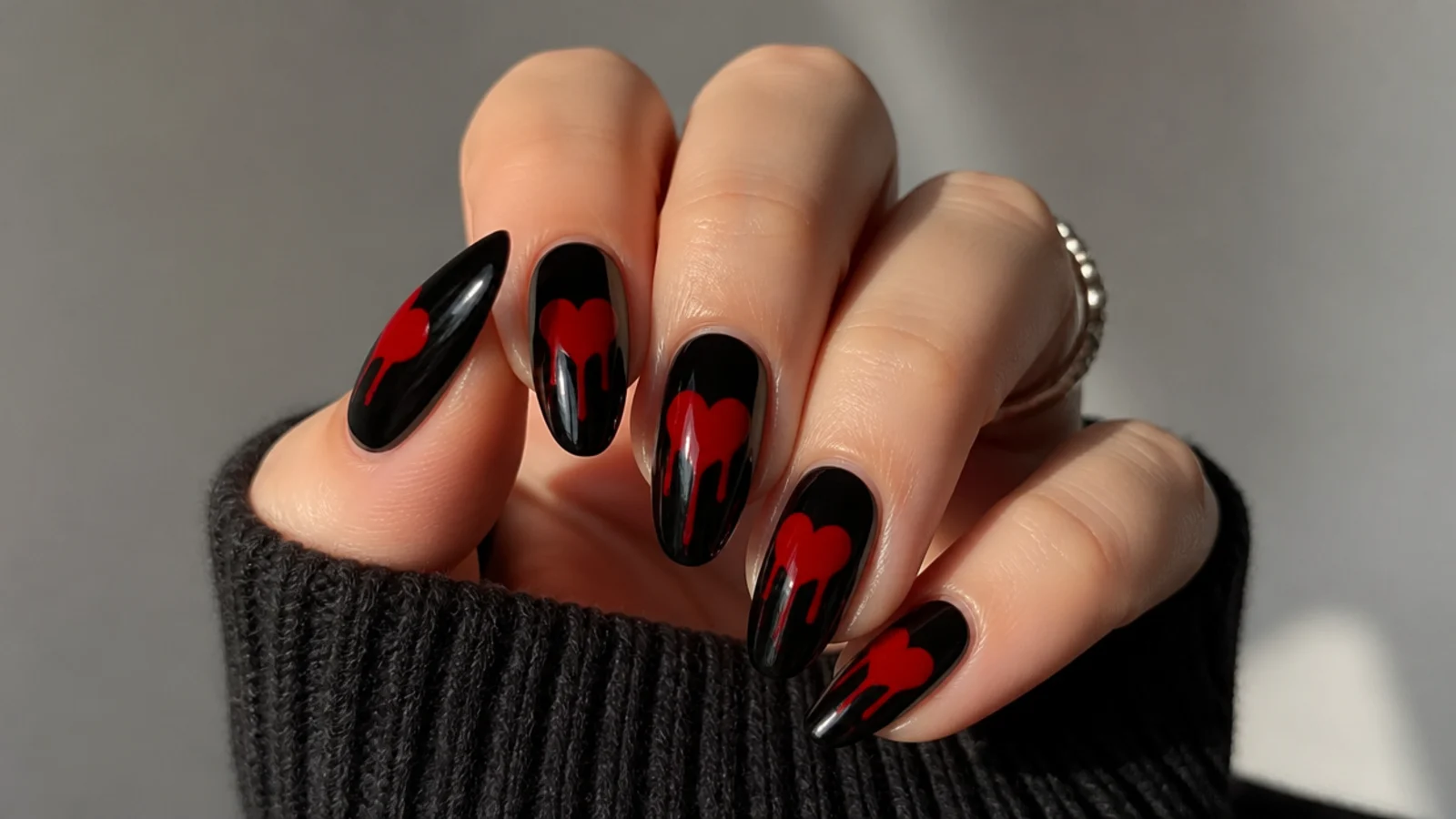 Black emo nails with a red heart dripping down the nail