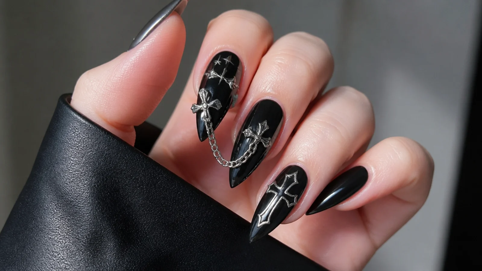 Black emo nails with silver cross and chain charm accents