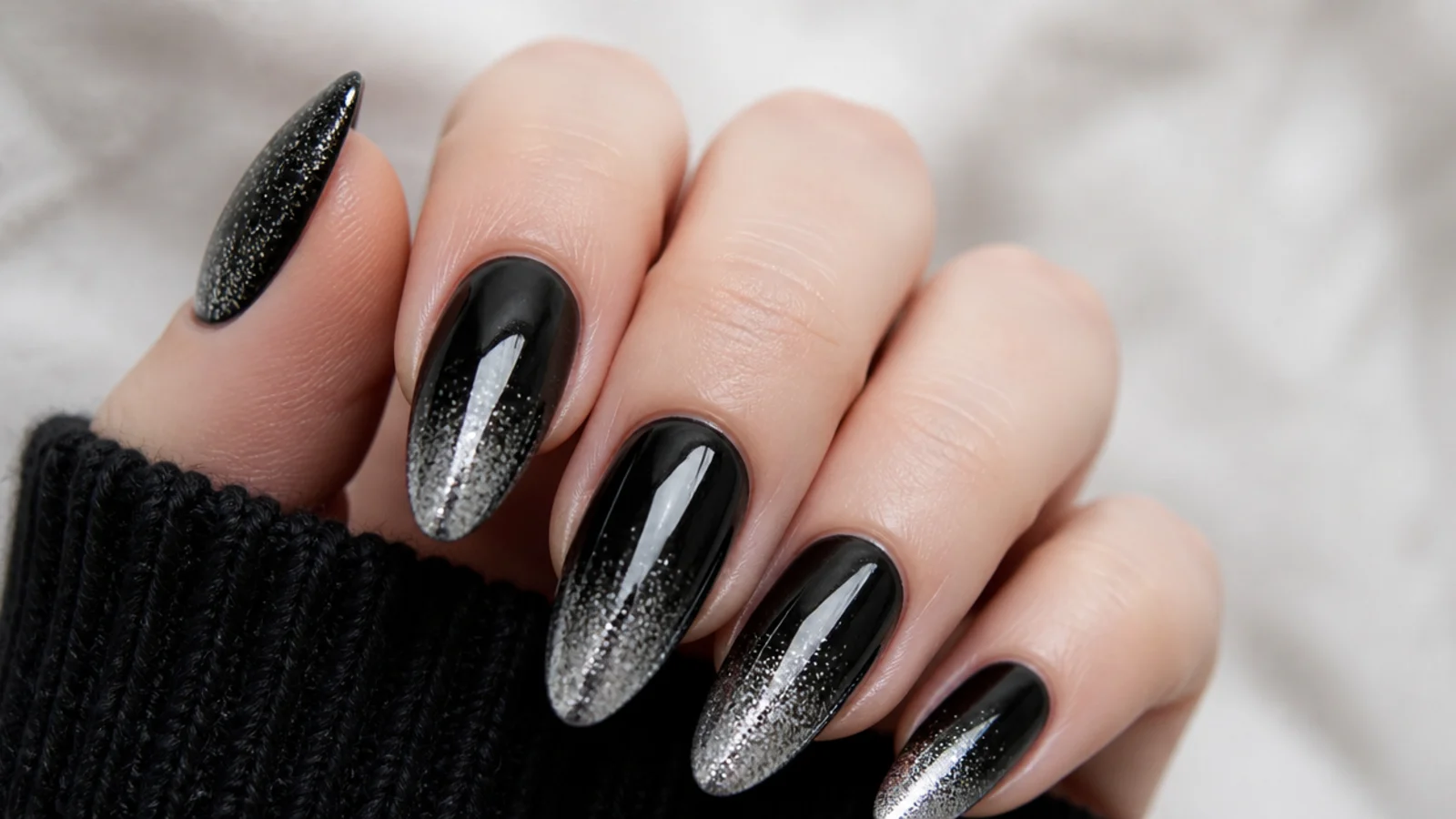 Black emo nails fading into silver glitter at the tips
