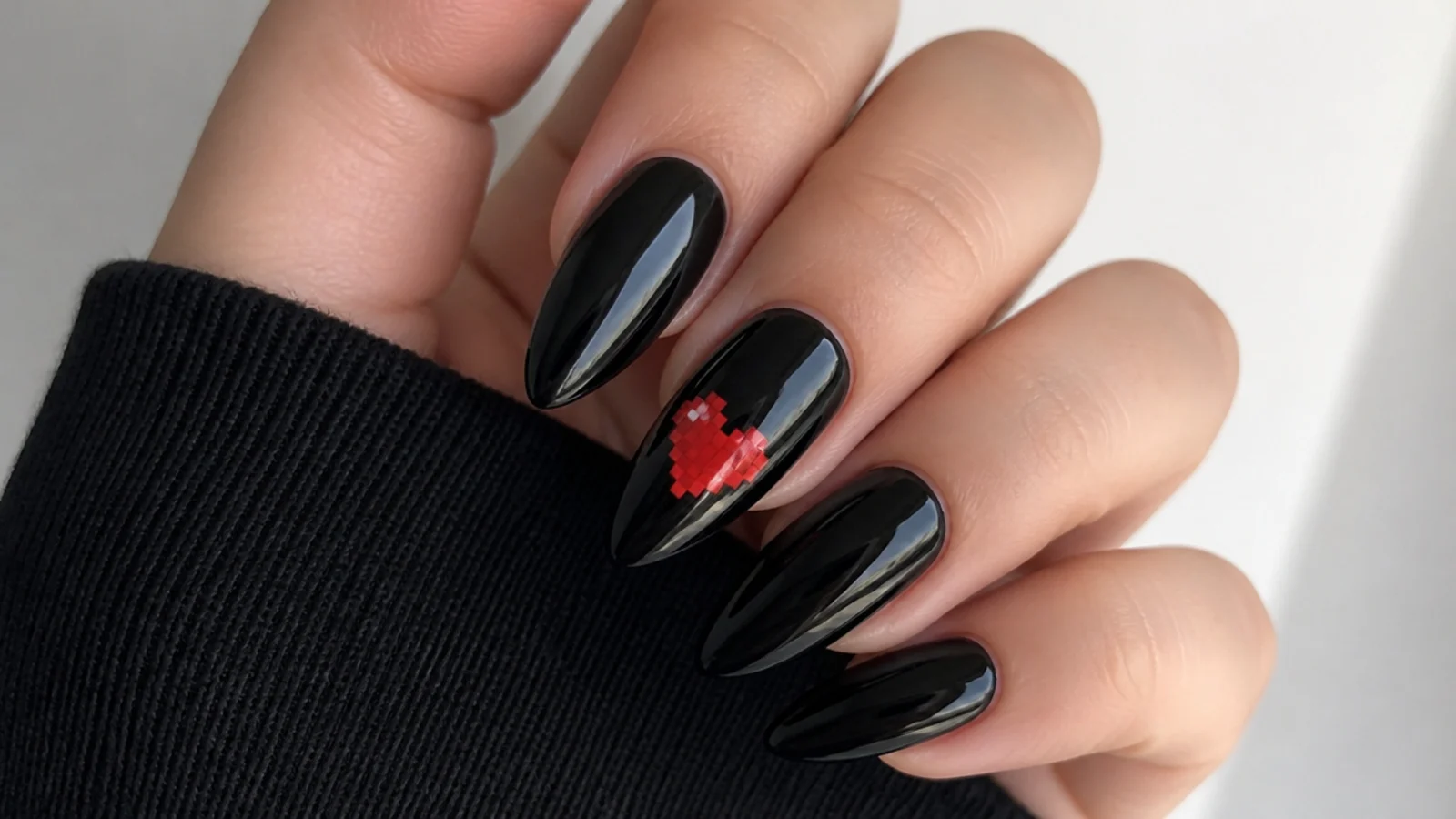 Black emo nails with a pixelated red pixel heart accent