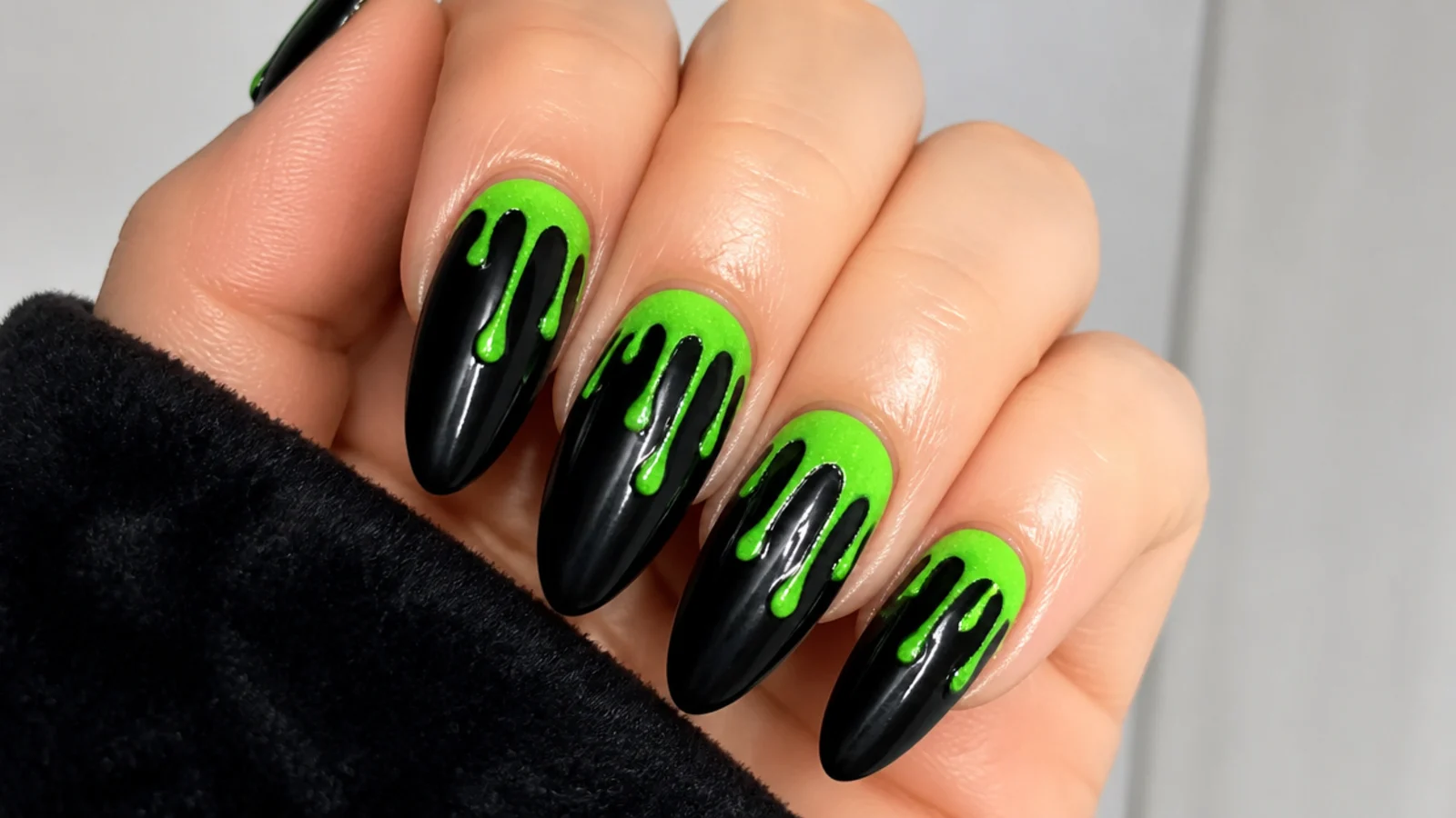 Black emo nails with neon green slime dripping from the cuticle