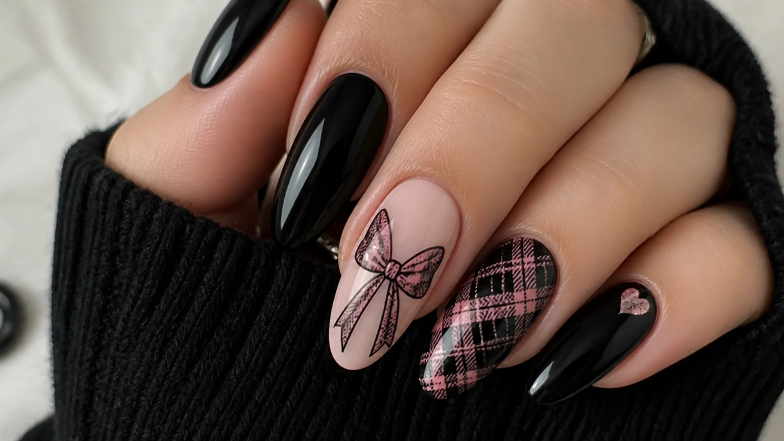 Black emo nails with a pink and black plaid bow accent